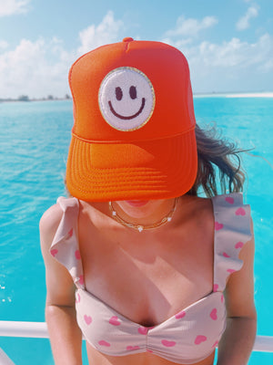 ORANGE TRUCKER HAT WITH WHITE SMILEY FACE ☻